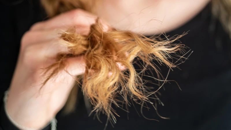 Woman applying a natural remedy to her hair to get rid of split ends overnight